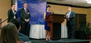 Candice Bennett, who nominated Cheryl Ellsworth for a Citation of Merit, and David Levine, President and CEO of Good Shepherd Housing & Family Services, watch as Cheryl thanks Fairfax Federation President Tim Thompson for her Citation of Merit