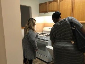A Good Shepherd Housing & Family Services Inc. employee shows an apartment to a prospective tenant. Good Shepherd subleases apartments in Fairfax County. 