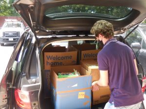 GSH Staff Member Brian Kelleher loads a car with books