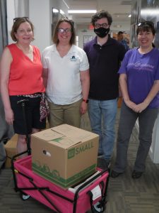 GSH Staff Betsy Damitz, Candice Bennett, Brian Kelleher, and Shannon Stockton pose for a photo with their books.