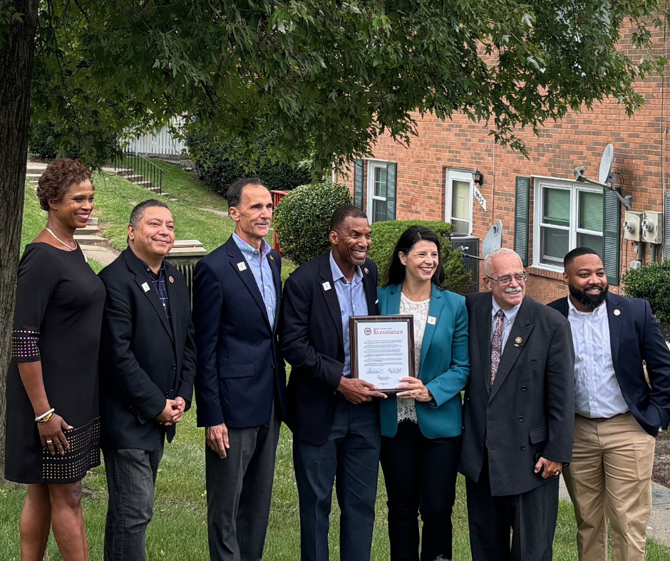 Photo of resolution presentation at ribbon cutting. Pictured from L to R: GSH Board Chair Erica McCants, Mason District Supervisor Andres Jimenez, Mount Vernon District Supervisor Dan Storck, Franconia District Supervisor Rodney Lusk, GSH Executive Director Genee Hayes, Congressman Gerry Connolly, Delegate Rozia Henson